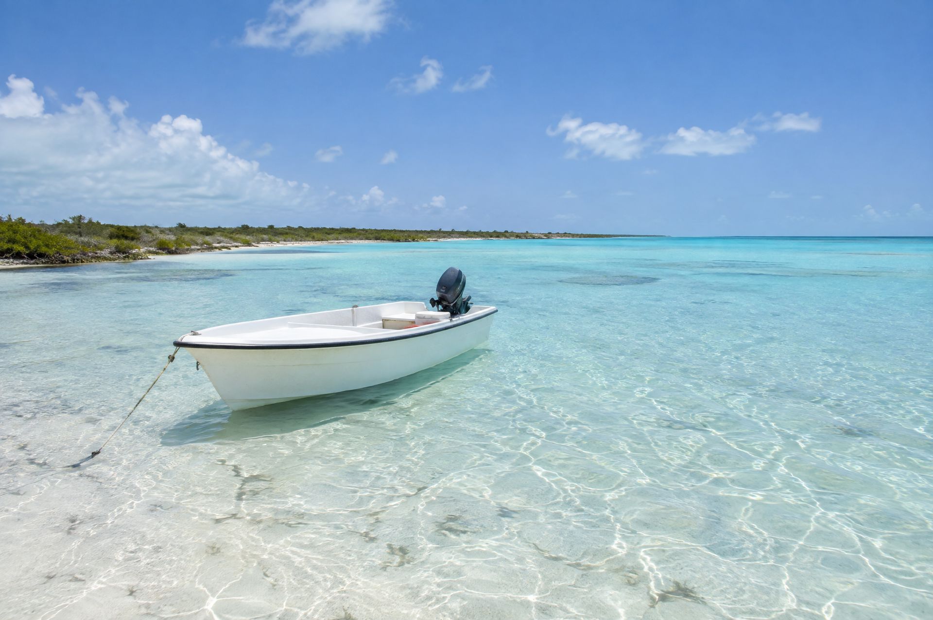 A skiff anchored on the knee-deep flats of the Bight of Acklins