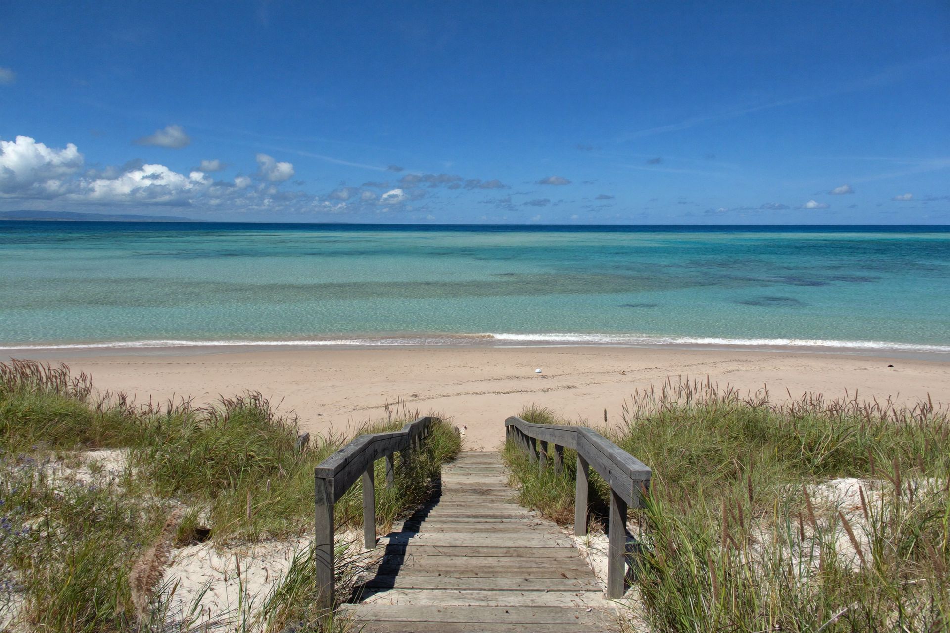 Beach stairs down to a pink-sand beach on Cat Island