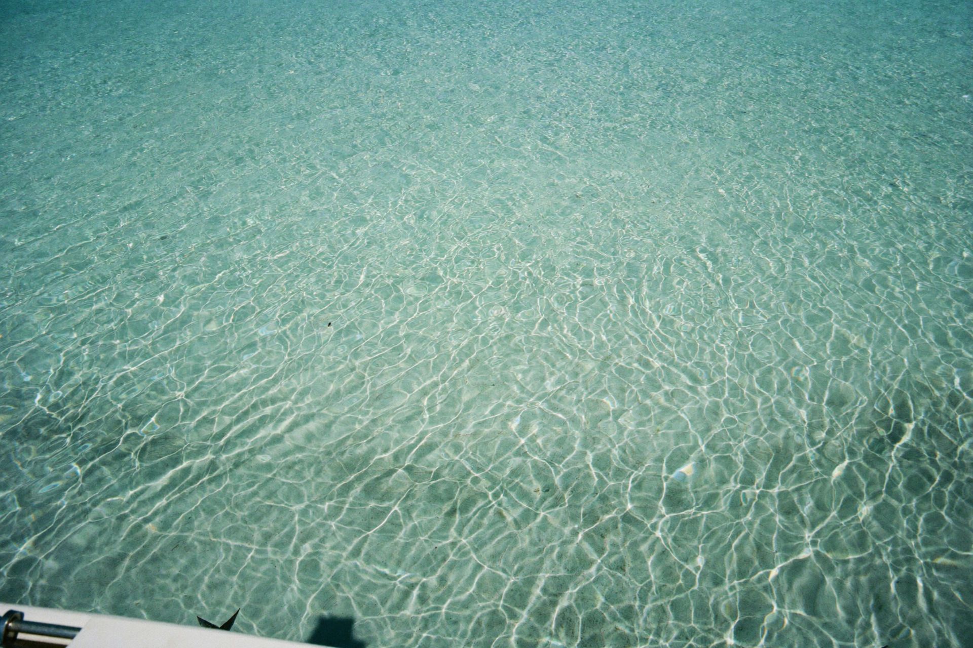 Crystal-clear turquoise water over white sand