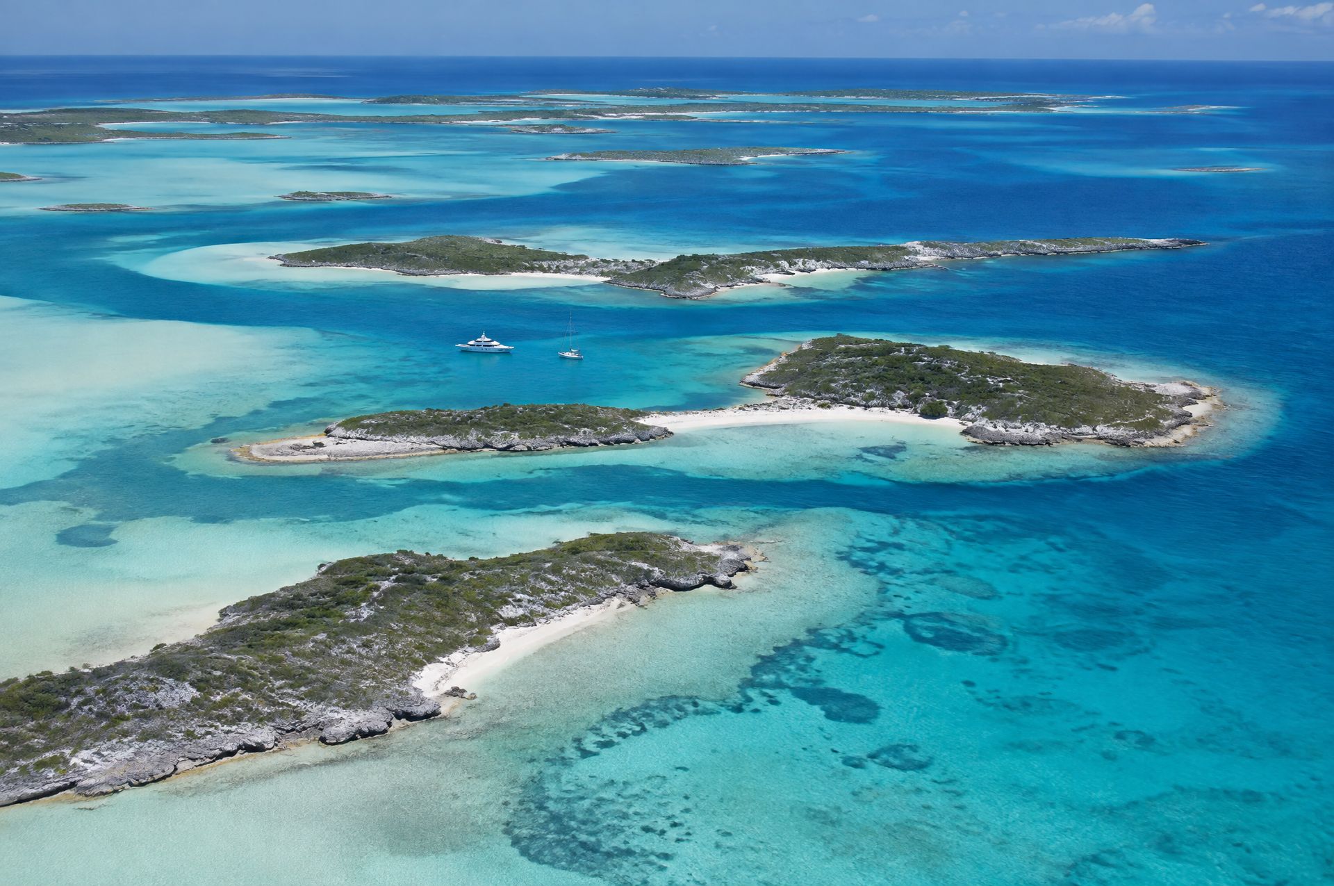 The Exuma Cays from the air: small flat cays, sand banks and deep blue channels