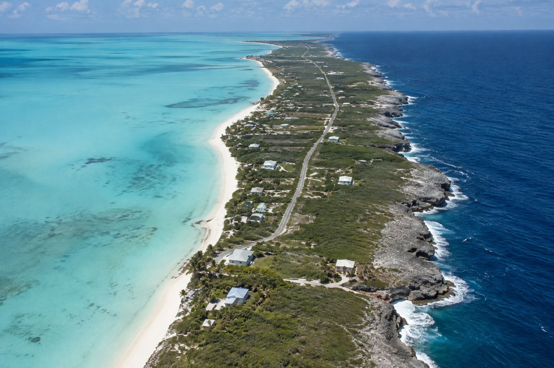 Long Island from the air, calm turquoise shallows on one side and the Atlantic on the other