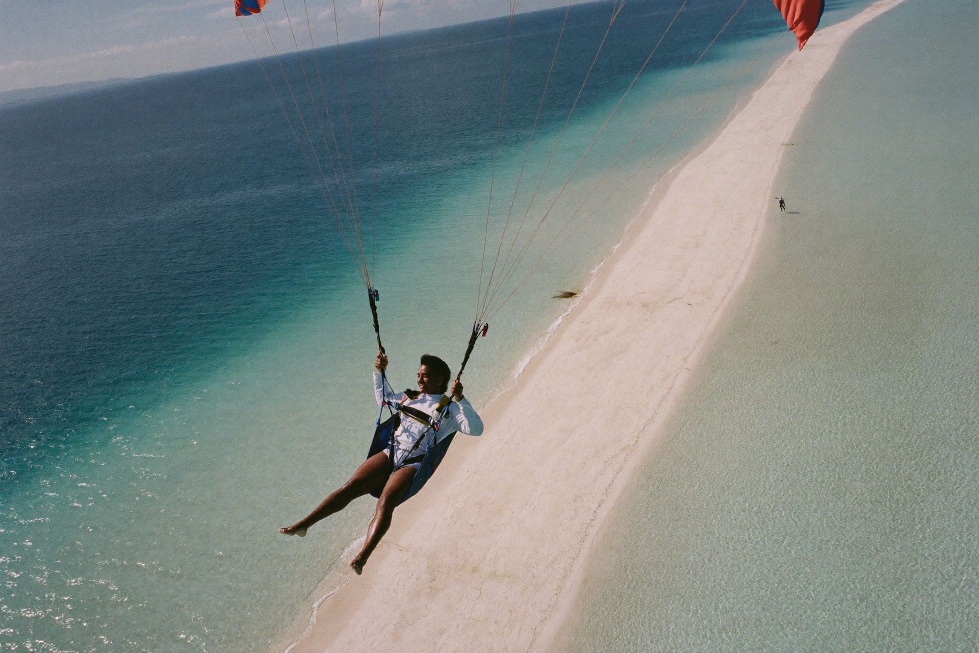 Tandem paragliding along a New Providence beach