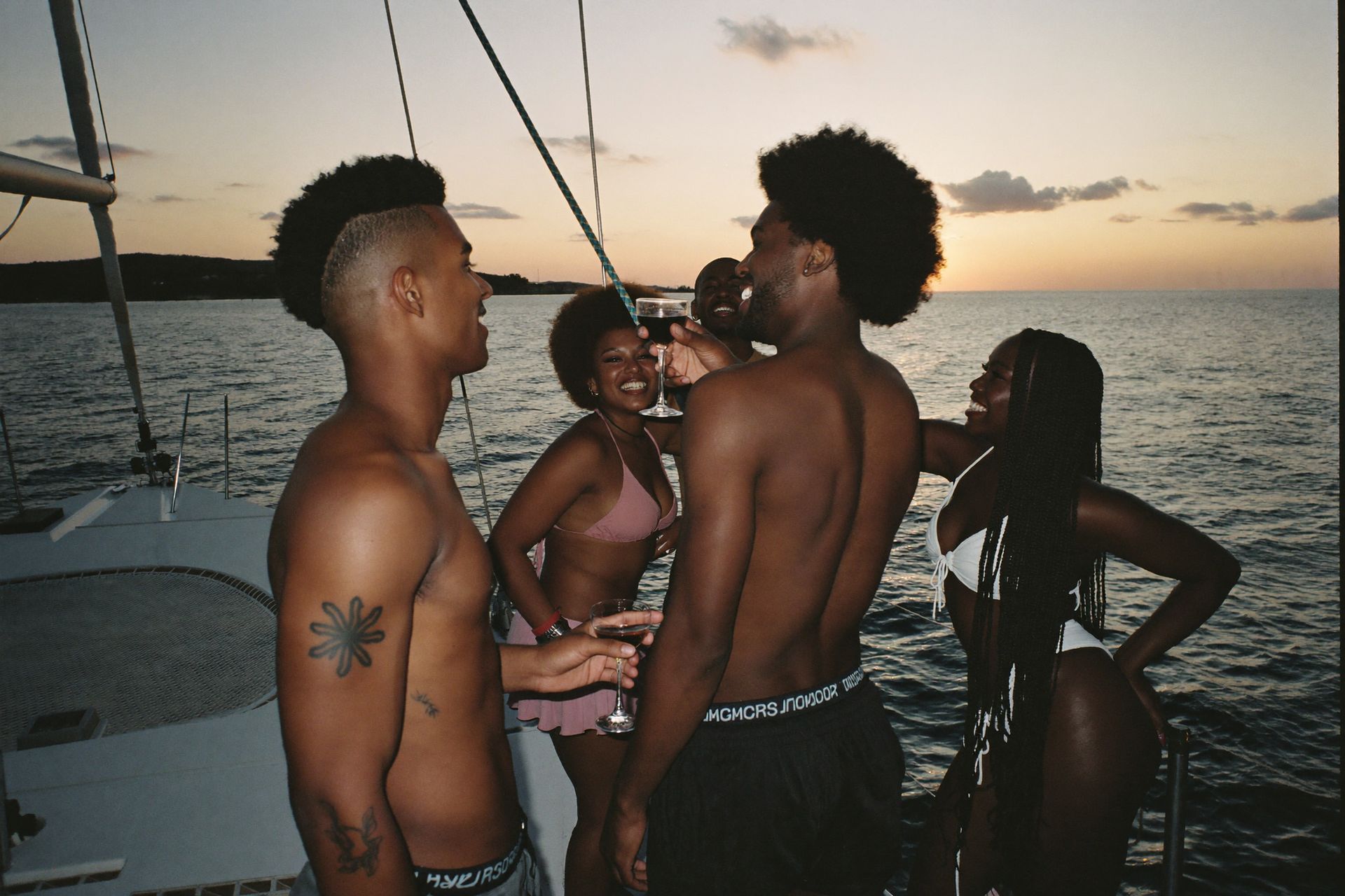 Friends on a catamaran at sunset off Nassau