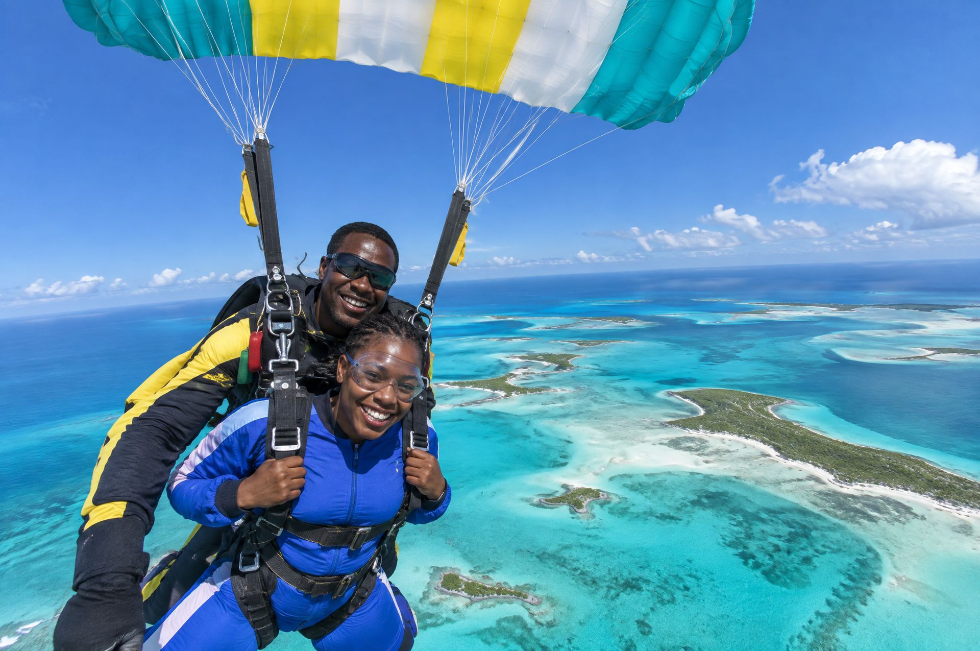 A tandem skydive under canopy above the turquoise cays of the Bahamas